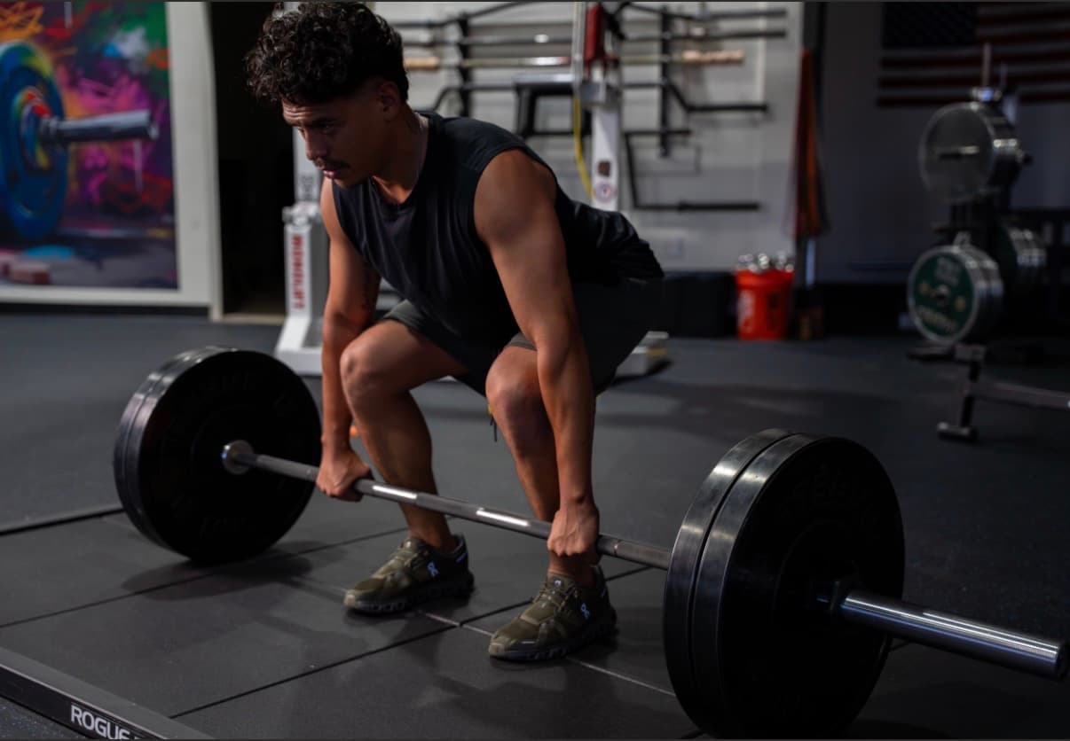 Jaime coaching a client through a deadlift at Moving Forward Fitness